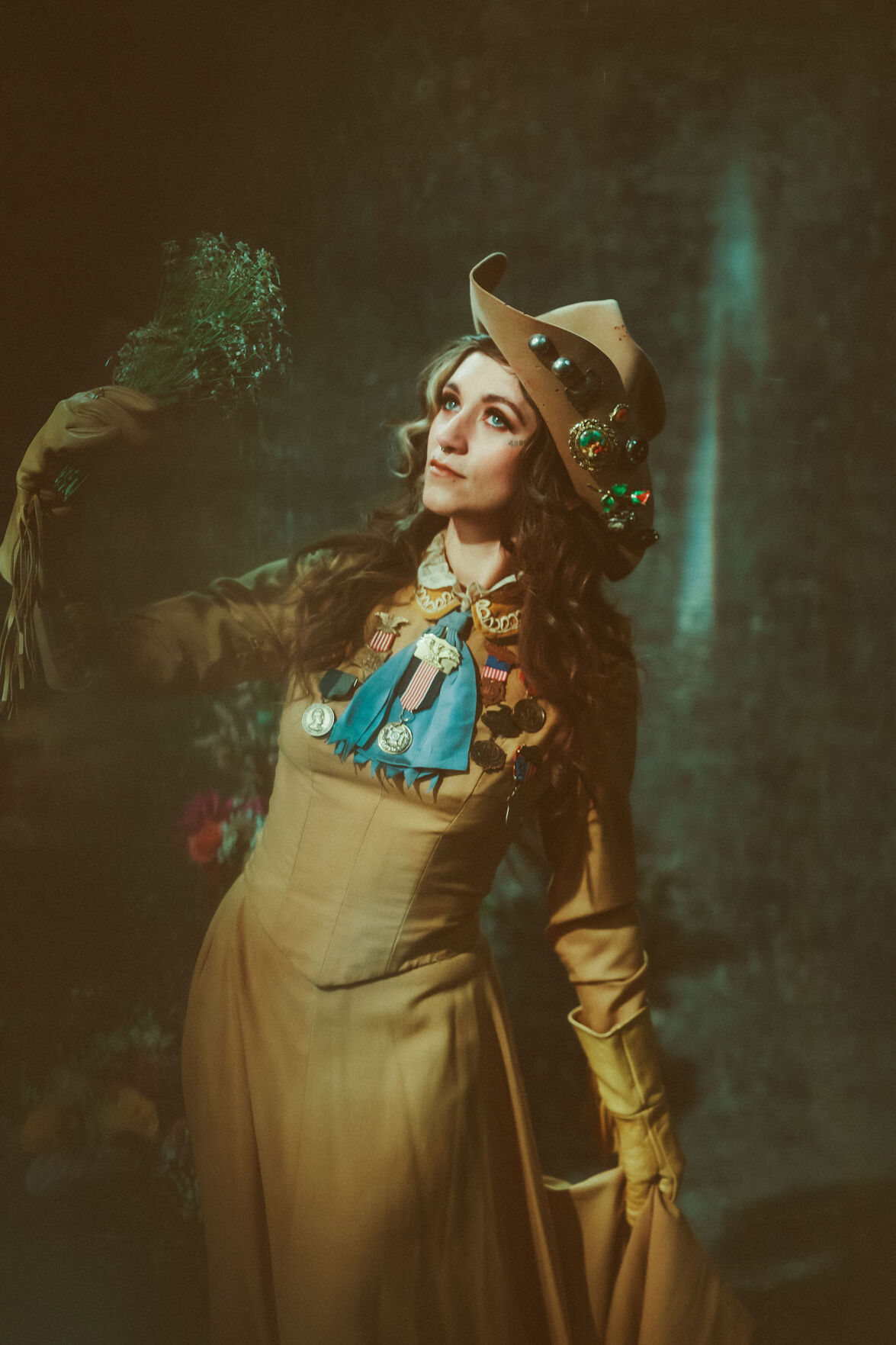 Sierra Ferrell press photo artist wears an ornate Western outfit and holds a bouquet